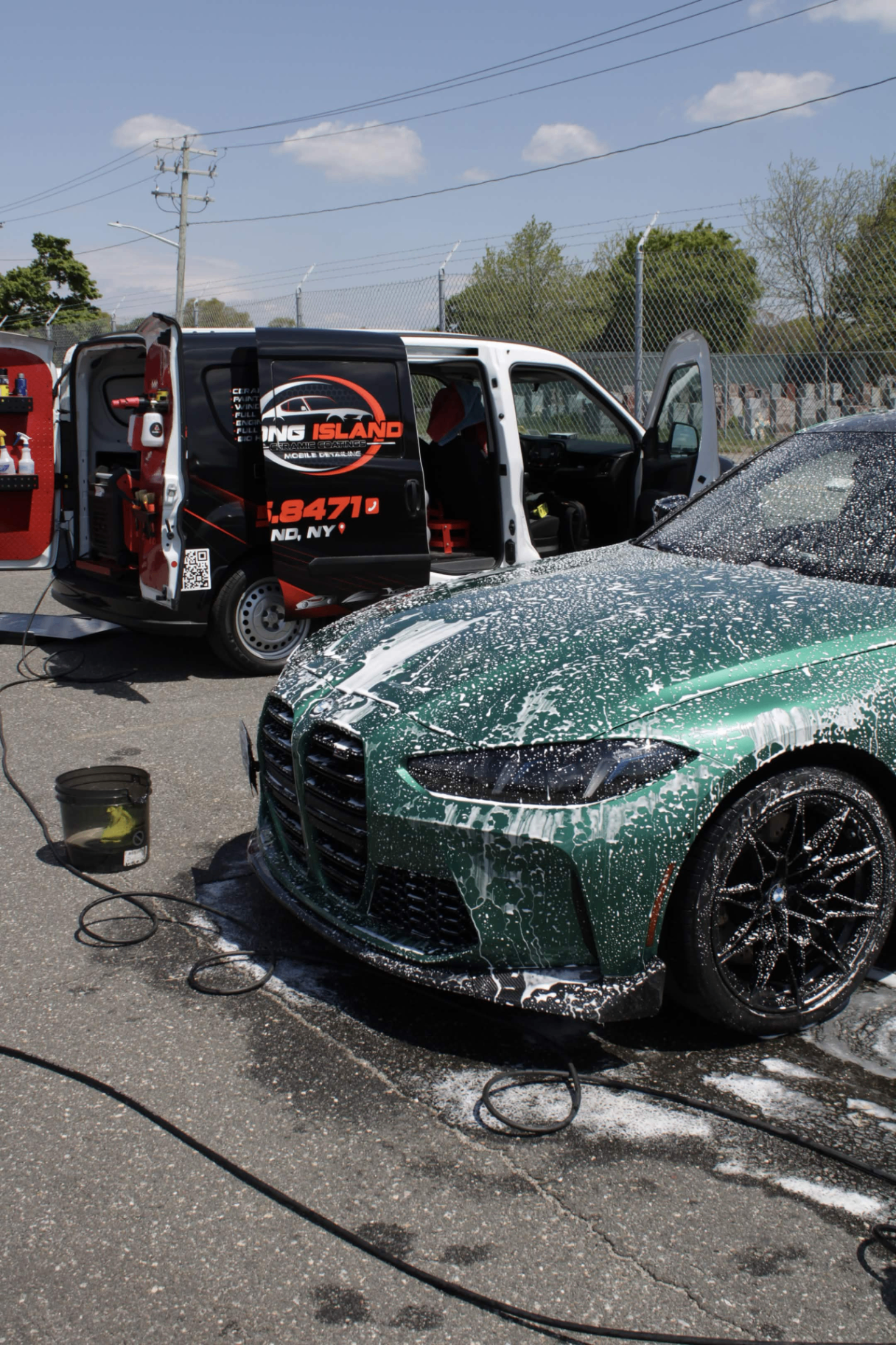 Glossy black car with water beading after ceramic coating